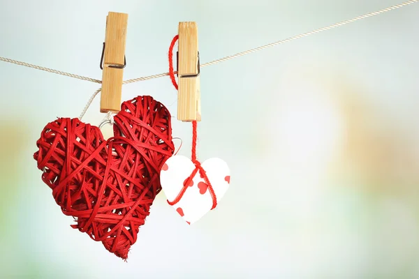 Hearts hanging on rope on bright background — Stock Photo, Image