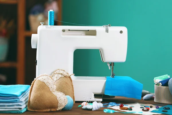 Sewing machine on table in workshop — Stock Photo, Image