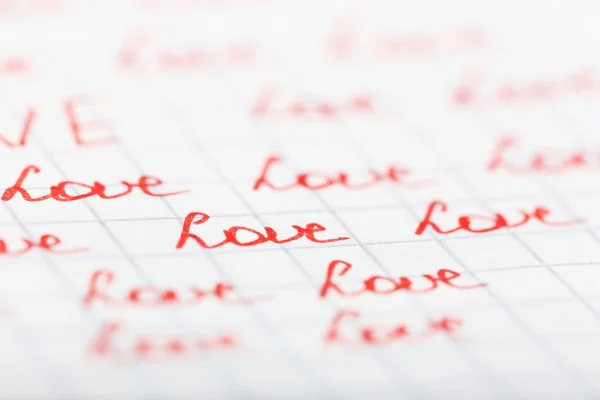 Palabras AMOR escrito en la hoja de fondo de papel — Foto de Stock