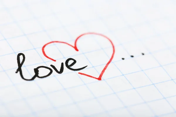 Word LOVE with heart written on sheet of paper background — Stock Photo, Image