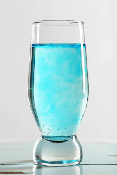 Glas Wasser auf dem Tisch auf hellem Hintergrund — Stockfoto