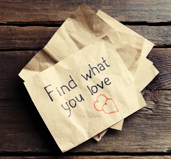 Written message on piece of paper on wooden table close up — Stock Photo, Image