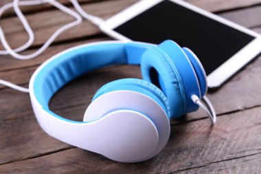 tablet ahşap arka plan üzerinde kulaklık