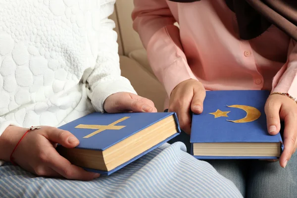 Two friends holding books with religions symbols — Stock Photo, Image