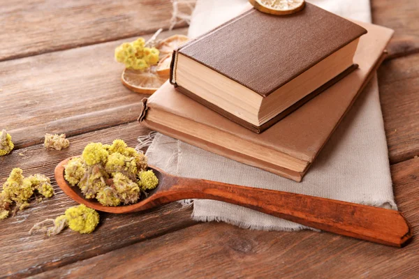 Old books with dry flowers on table close up — Stock Photo, Image