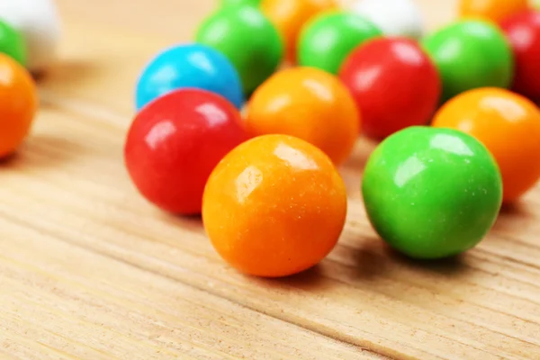 Ahşap masa, closeup üzerinde renkli şekerler — Stok fotoğraf