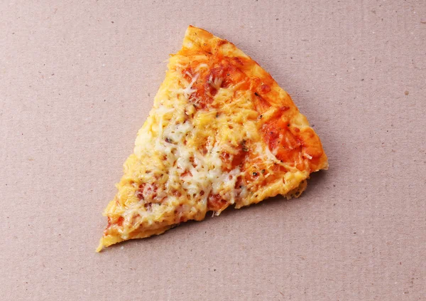 Pedazo de pizza sobre fondo de cartón —  Fotos de Stock