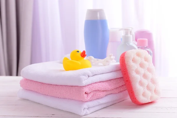 Baby accessories for bathing on table on light background — Stock Photo, Image