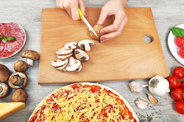 Woman making pizza on table close up — Stock Photo, Image