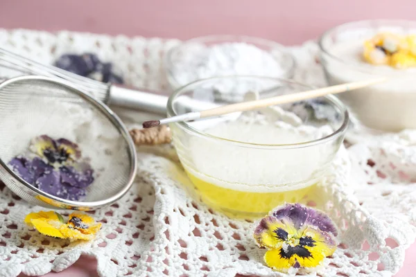 Making candied violet flowers with egg whites and sugar, on color wooden background — Stock Photo, Image