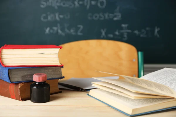 Teachers workplace  on blackboard background — Stock Photo, Image