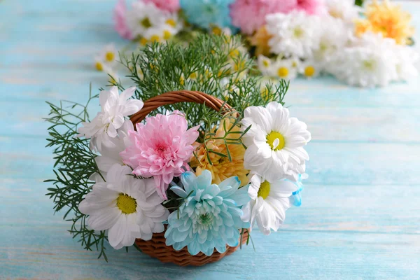 Colorful chrysanthemum in basket on wooden background — Stock Photo, Image