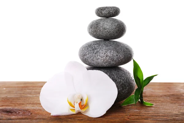 Stack of spa stones with orchid flower isolated on white — Stock Photo, Image