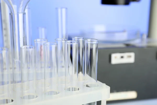 Test tubes and microscope in laboratory — Stock Photo, Image