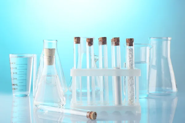 Empty laboratory test tubes  on blue background — Stock Photo, Image