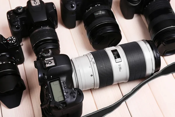 Modern cameras on wooden table — Stock Photo, Image