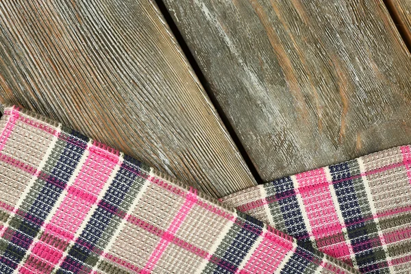 Checkered napkin on wooden table — Stock Photo, Image