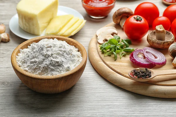 Ingredients for cooking pizza on wooden table — Stock Photo, Image