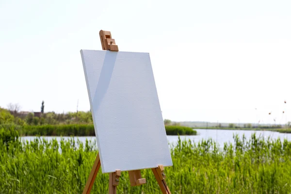 Easel with canvas outdoors — Stock Photo, Image