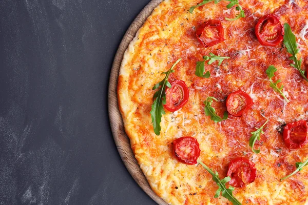 Pizza com arugula e tomate cereja em fundo de madeira — Fotografia de Stock