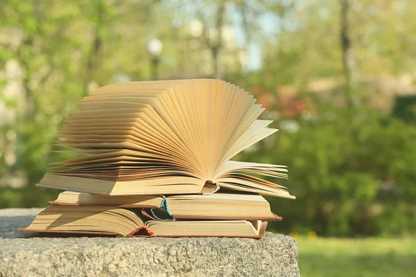 Stack of books outdoors, on blurred background — Stock Photo, Image