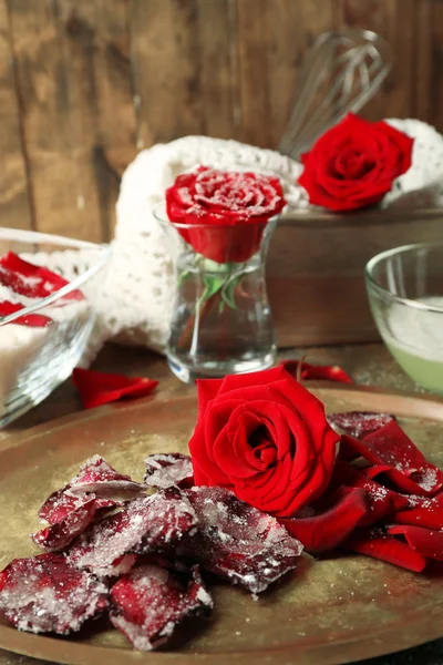 Making candied rose flower petals with egg whites and sugar, on wooden background — Stock Photo, Image