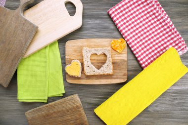 Bread slice with cut in shape of heart and cheese