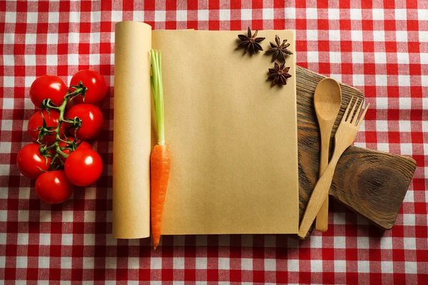 Livro de receitas aberto na toalha de mesa — Fotografia de Stock