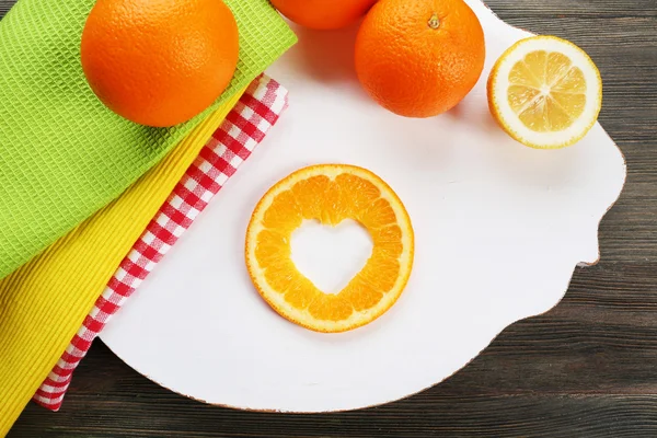 Orange slice with cut in shape of heart — Stock Photo, Image