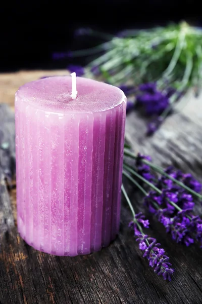 Candle with lavender flowers on table close up — Stock Photo, Image