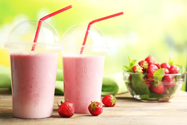 Glasses of milkshake with strawberries — Stock Photo, Image
