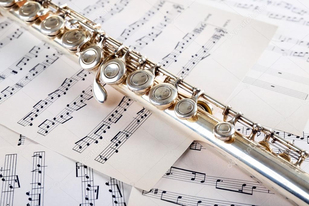 Flute on music notes background Stock Photo by ©belchonock 76224533
