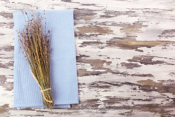 Belles fleurs sèches sur serviette sur fond en bois — Photo