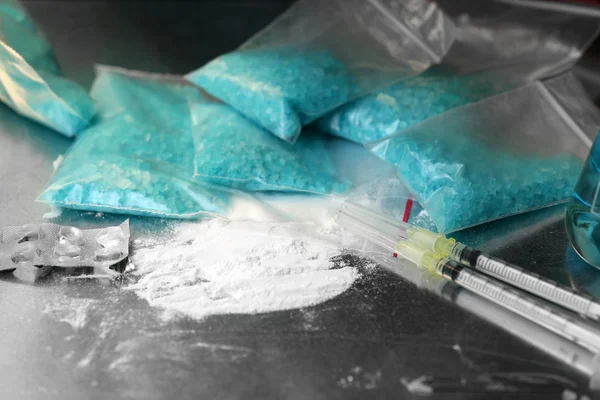 Drug laboratory: blue methamphetamine and money on table close up — Stock Photo, Image