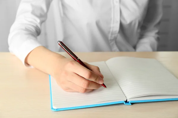 Businesswoman writing on document — Stock Photo, Image