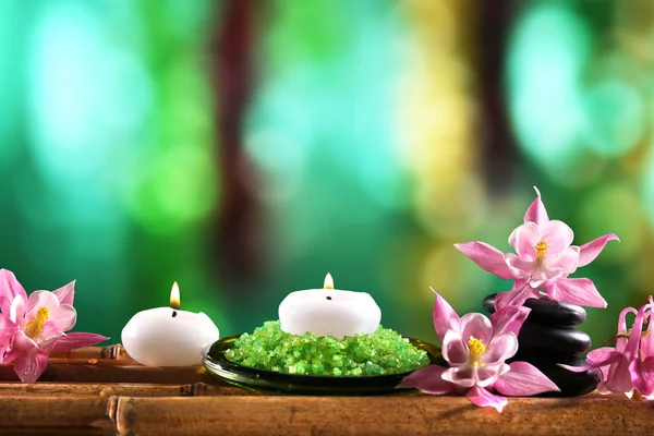 Beautiful spa composition with flowers and candles on bright background — 图库照片