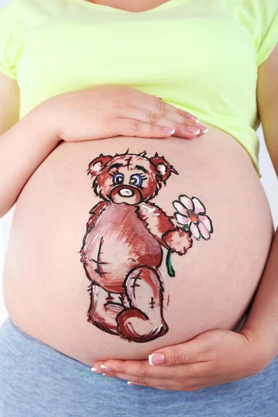 Body art on belly of pregnant woman on light background — Stock Photo, Image