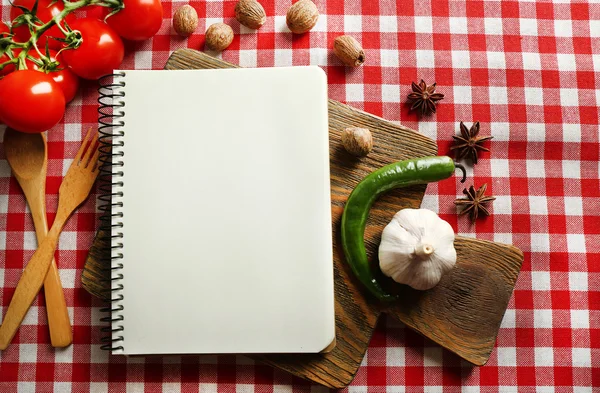 Open recipe book on tablecloth background — Stock Photo, Image