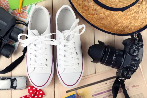 Female gumshoes with accessories on wooden background — Stock Photo, Image