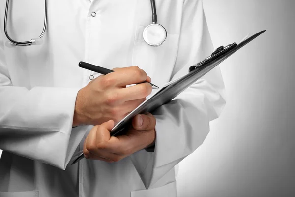 Male doctor with folder close up — Stock Photo, Image