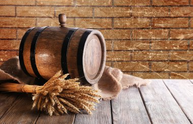 Beer barrel with beer on table