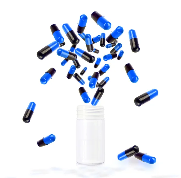 Pills flying  from open  bottle — Stockfoto