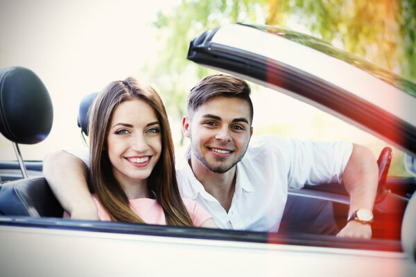 Young couple in cabriolet, outdoors