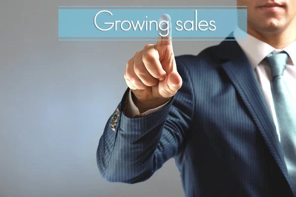 Businessman hand touching Growing sales icon — Stock Photo, Image