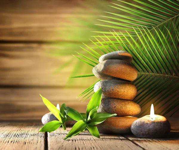 Spa stones, candle on wooden background — Stock Photo, Image