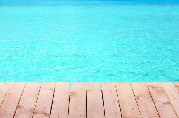 Wooden pier with blue sea background — Stock Photo, Image