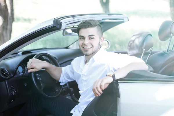 Young man in cabriolet, outdoors — Stock Photo, Image