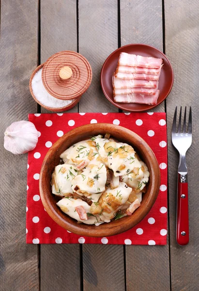 Fried dumplings with onion and bacon in frying pan — Stock Photo, Image