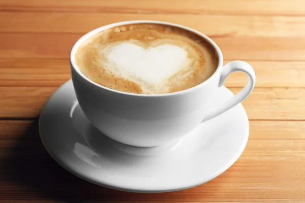 Cup of coffee latte art on wooden background — Stock Photo, Image