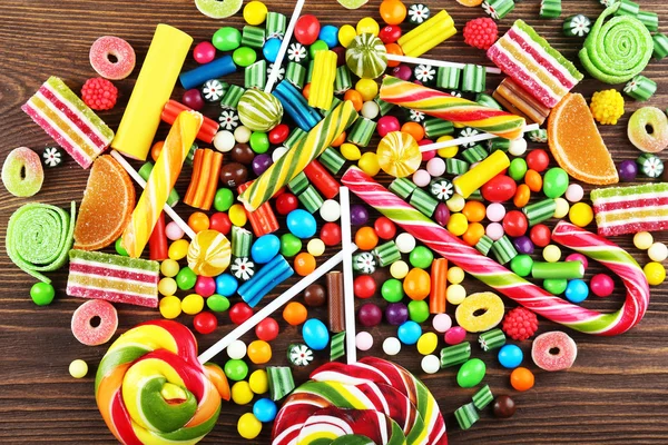 Colorful candies on wooden background — Stock Photo, Image